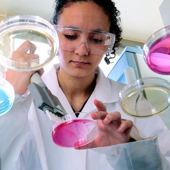 Woman pipetting into petrie dish.jpg